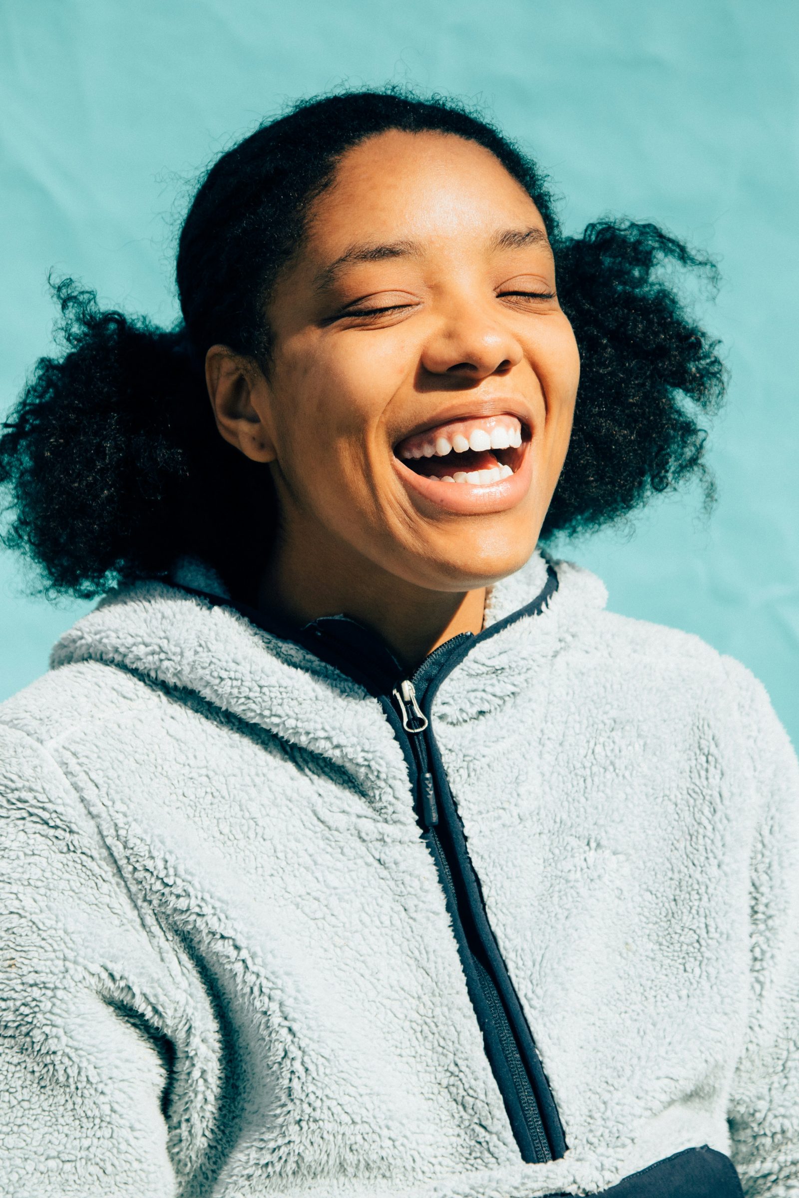 Laughing patient in a cosy hoodie